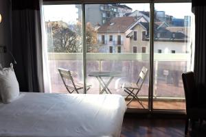 Postel nebo postele na pokoji v ubytování Hôtel Du Centre Annemasse