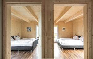 two beds in a room with wooden walls at Nice Home In Turrach With 4 Bedrooms And Internet in Turracher Hohe