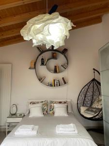 a bedroom with a bed and a chandelier at Habitaciones con encanto 