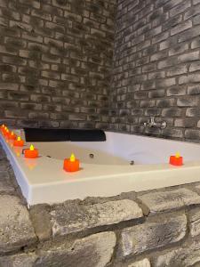 a bath tub in a room with a brick wall at Taş Mahall Luxury Hotel in Sile