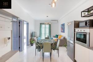 a kitchen and living room with a table and chairs at Fully equipped home, with balcony in St Julians by 360 Estates in St Julian's