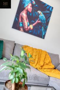 a painting of a woman with a bird on a couch at Fully equipped home, with balcony in St Julians by 360 Estates in St Julian's