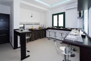 a kitchen with a black counter and bar stools at B&B Alla Stazione in Palermo