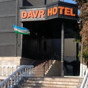 a flag flying in front of a door of a building at DAVR хостел in Namangan