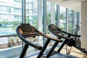 a gym with a treadmill and a large window at HiGuests - Magnificent Apt with Panoramic Views All Around in Dubai