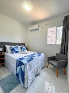 1 dormitorio con 1 cama, 1 silla y 1 ventana en Bella Vida Casa Azul en Morro de São Paulo