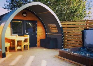 a small shed with a table and a window at Henfields Country Retreat in Otterhampton