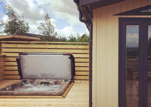 a large tv sitting on the side of a house at Henfields Country Retreat in Otterhampton