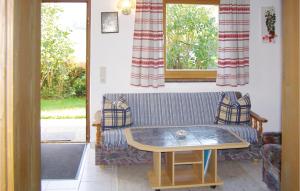 a living room with a couch and a table at Nice Home In Breitenbach With 2 Bedrooms in Breitenbach am Inn