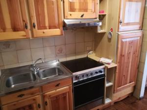 a kitchen with a sink and a stove at Ciasa de Carla in Masarè +6 photos