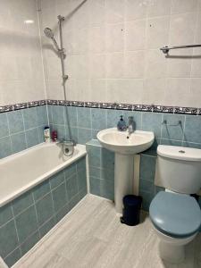a bathroom with a toilet and a sink at Spacious 5 Bedroom House- Harry potter world & London in Watford