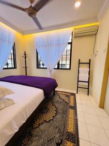 a bedroom with a bed and a chair and windows at D Riad Ipoh Homestay l Home Cinema l 300MBPS in Ipoh