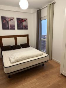 a bedroom with a bed and a window with a view at Estepona Center in Estepona +29 photos