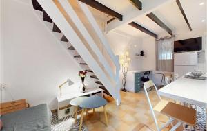 sala de estar con escalera, mesa y sillas en 1 Bedroom Beautiful Home In Dolus-dolron, en Dolus d'Oléron