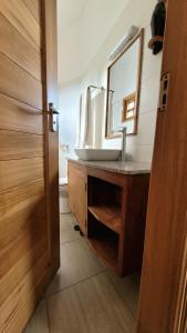 a bathroom with a sink and a mirror at Babylon Lodge in Marangu