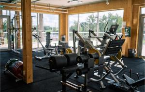 a gym with several tread machines in a room at Stunning Apartment In Stjrnhov With Ethernet Internet in Stjärnhov