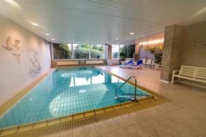 a large swimming pool in a large building at Haus "Luv und Lee" Appartement LUV31 in Cuxhaven