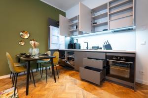 a kitchen with a table and a dining room at Brand new 2-room central apartment in Vienna