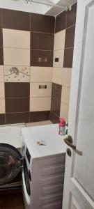 a bathroom with a toilet and a sink at Apartament in Craiova