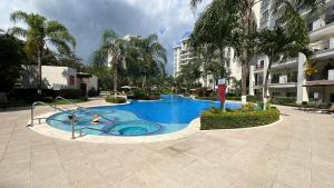 a swimming pool in the middle of a building at Private Modern Condo by Jac Beach in Jacó