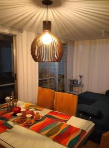 a dining room with a table and a light at Tu mejor decisión a 20 minutos de Bogotá. in Mosquera