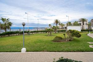 a park with palm trees and a street light at Moderne appart résidence privée in Tangier