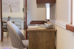 a room with a desk with two chairs and a table at VacationClub - Bukowa 6B Apartament 26 in Wisła