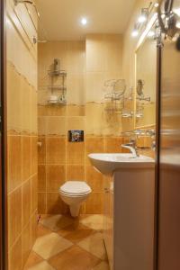 a bathroom with a toilet and a sink at VacationClub - Bukowa 6B Apartament 26 in Wisła +10 photos
