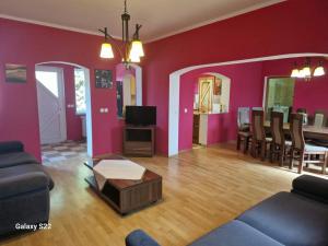 a living room with a couch and a dining room at CASA BOTIMI in Covasna