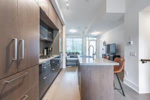 a kitchen with wooden cabinets and a counter top at Luxury Properties in Toronto Downtown Core in Toronto