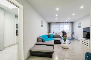 a living room with couches and a tv at Famille, Parking, Balnéo - 15min Centre in Strasbourg