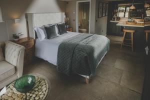 a bedroom with a bed and a living room with a couch at Everything Retreat in Mellor