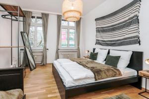 a bedroom with a large bed and two windows at Center Elegance Light Apartment in Krefeld