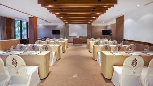 a conference room with rows of tables and chairs at Woodlands Hotel and Resort Pattaya in North Pattaya