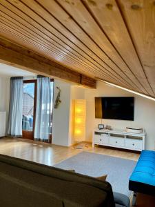 a living room with a couch and a flat screen tv at Appartements Mair in Strobl in Strobl