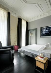 ローマにあるスイート アート ナヴォーナのベッドとソファ付きのホテルルーム