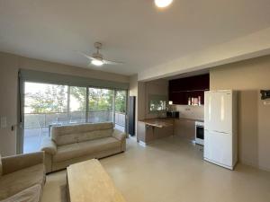 a living room with a couch and a white refrigerator at Sounion Green Retreat in Sounio