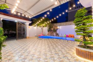 a large room with a blue floor and lights at Sea Villa Hồ Bơi Gần Biển Bãi Sau - Free Karaoke + Bida in Vung Tau +23 photos