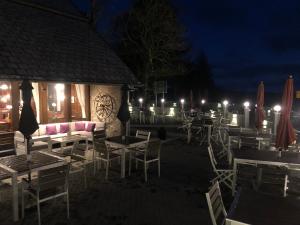 a restaurant with tables and chairs at night at Waldhotel Auerhahn "Hochkopfhaus" in Todtnau