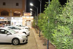 a row of cars parked in a parking lot at Yanbu Inn Residential Suites in Yanbu