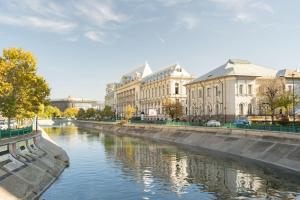 a river in a city with buildings and houses at Stunning Views Luxury Studio in Bucharest