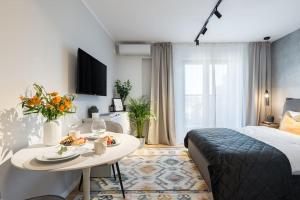 a hotel room with a bed and a table with food on it at Stunning Views Luxury Studio in Bucharest