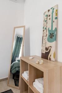 a dressing table with a mirror and a guitar on it at Brand New Bright modern 6bdr apt-1min to Acropolis in Athens
