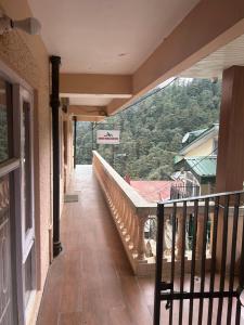 a balcony of a building with a view of a mountain at Himalayan view in Shimla