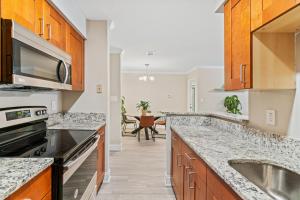 a kitchen with granite counter tops and a sink at W - Atlanta Luxury 1bdr 1bath ensuite shared Condo in prime location in Atlanta