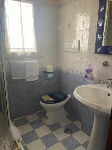 a bathroom with a toilet and a sink at Villa Chiara B&B in Civitavecchia