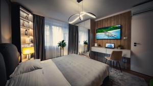 1 dormitorio con 1 cama y TV en la pared en Central Luxury Home, en Timisoara