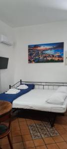 two beds in a room with a picture on the wall at La casa del Professore in Naples