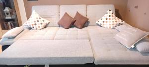 a white couch with pillows on top of it at Ferienwohnung “Haus Rita” in Riedlhütte