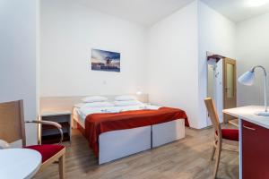 A bed or beds in a room at Apartmánový komplex Dagmar